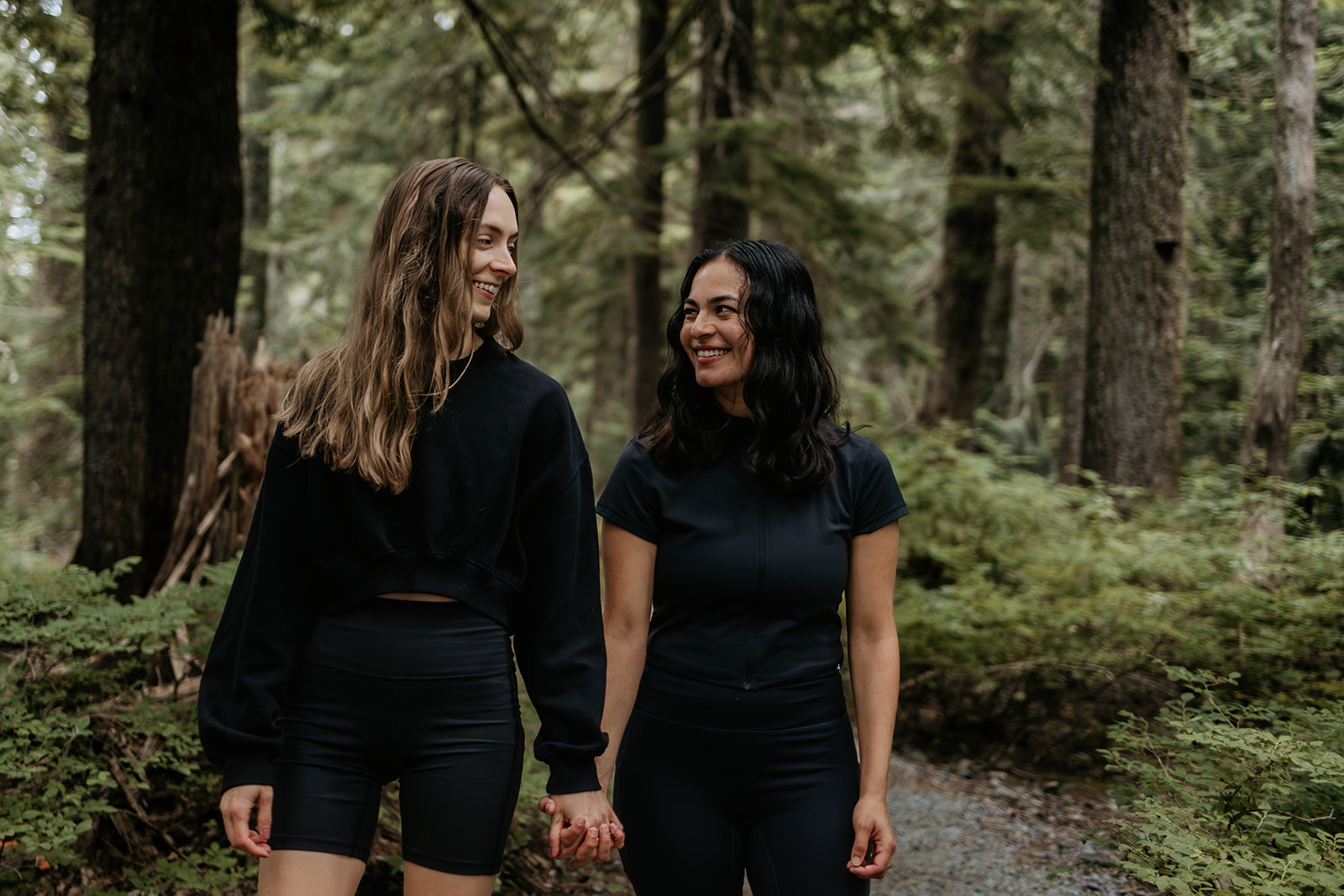Paola with her wife on a forest trail